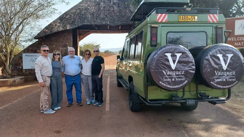 Vazquez Tours guests with safari vehicle in Rwanda
